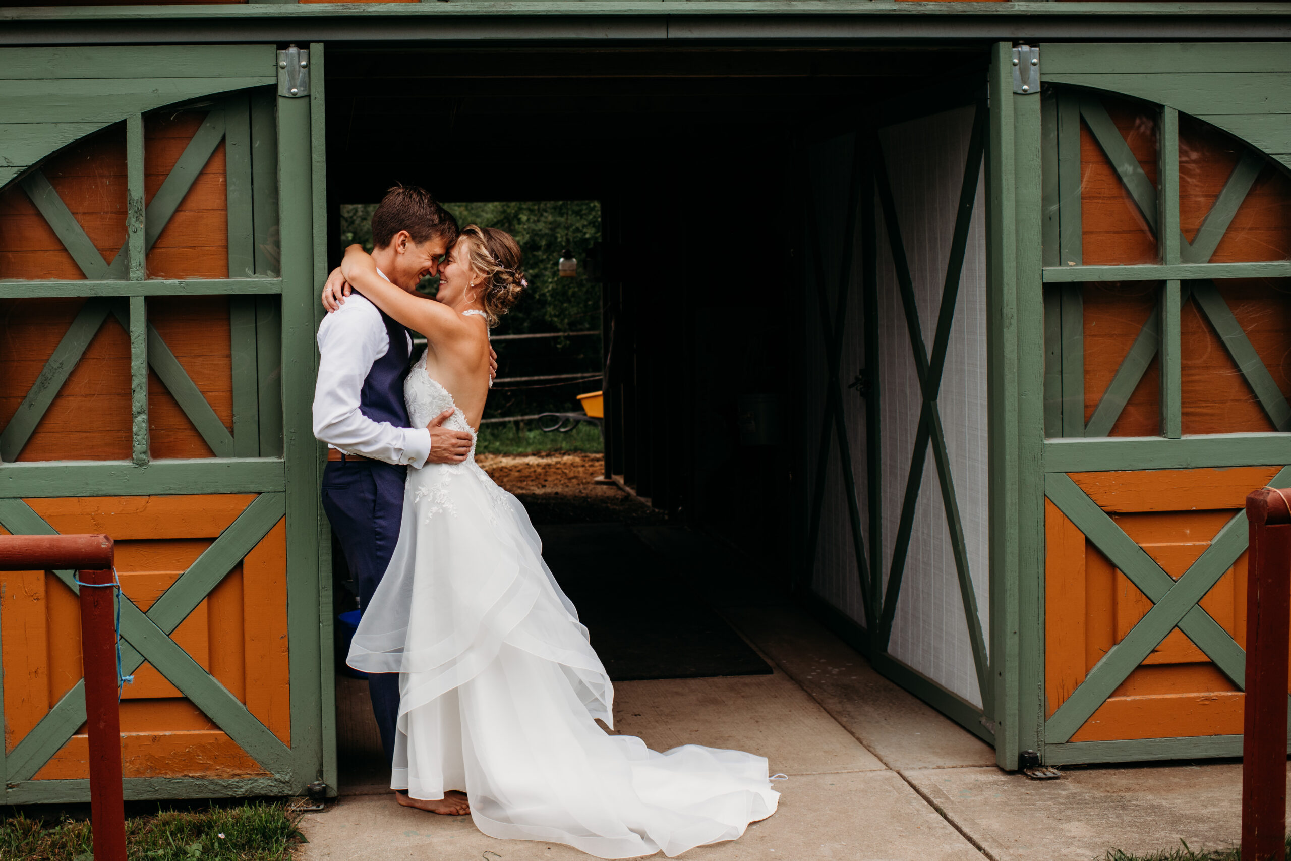 bride and groom embracing against their Wisconsin Barn Wedding venues