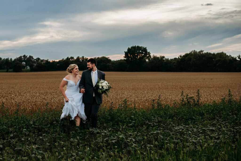 bride and groom running through a corn field Wisconsin Wedding Venues